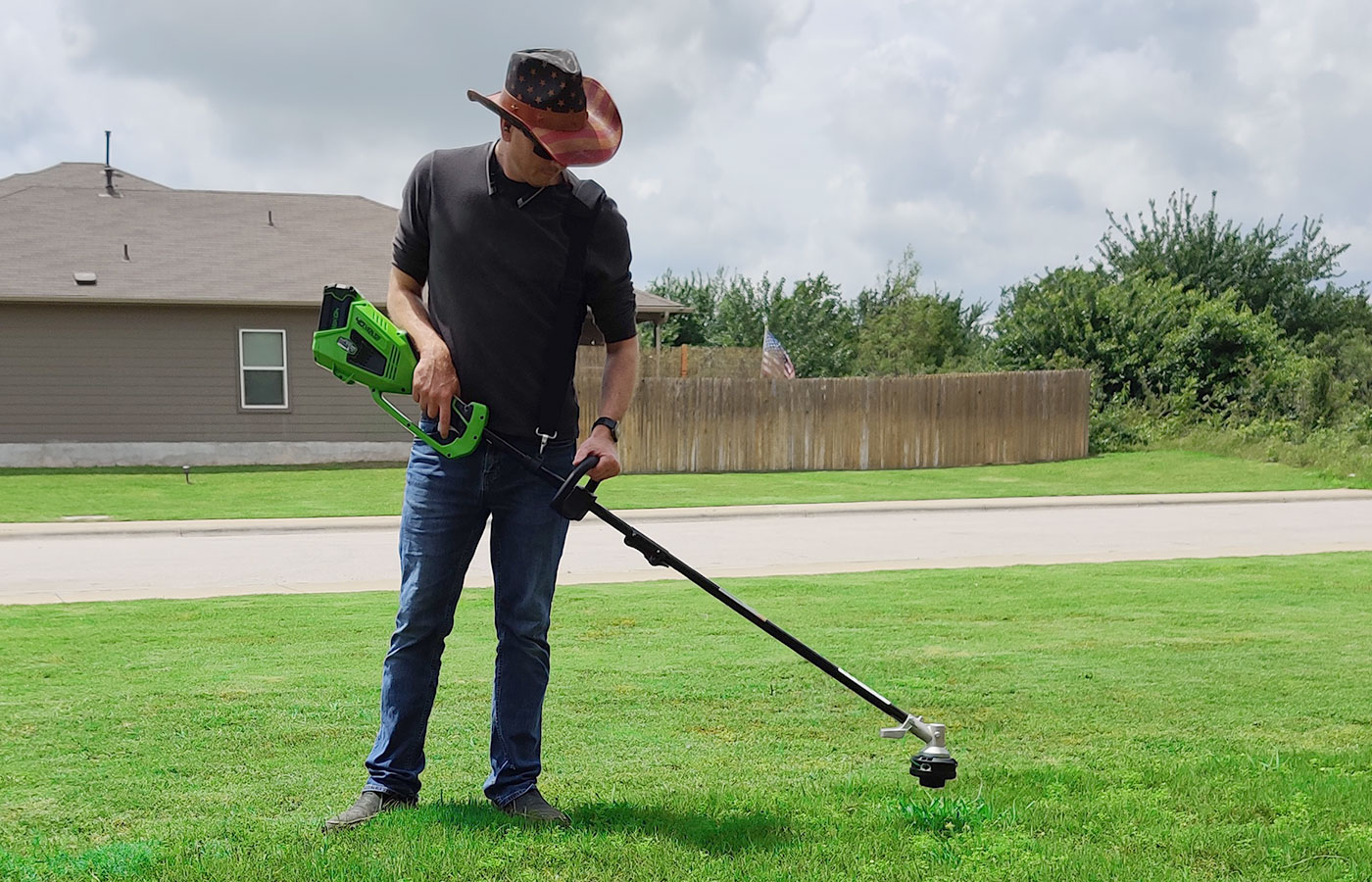 Trimming the edge of a freshly mowed lawn with a string trimmer